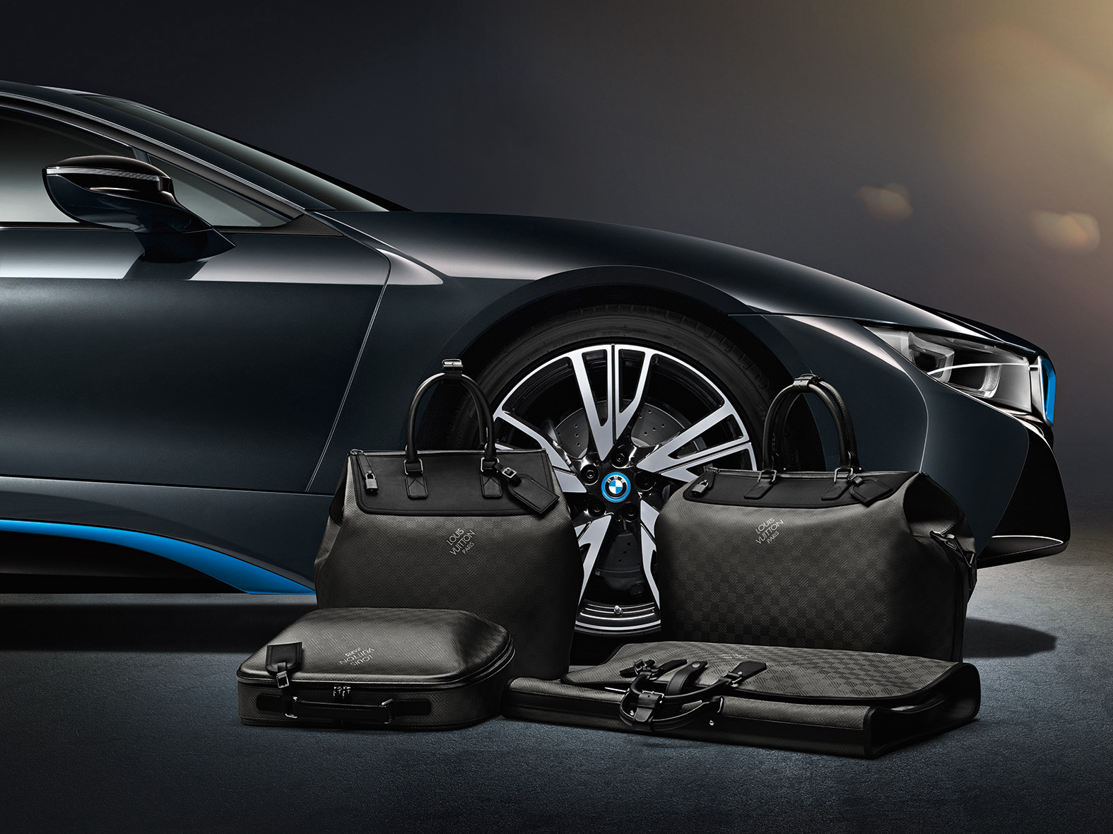 BMW i8 sports car with matching Louis Vuitton luggage set, showcasing a co-branding partnership.